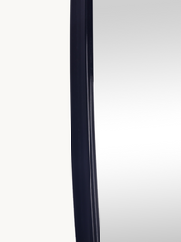 Close-up of the left edge showing the thin black PVC frame profile and mirror surface detail