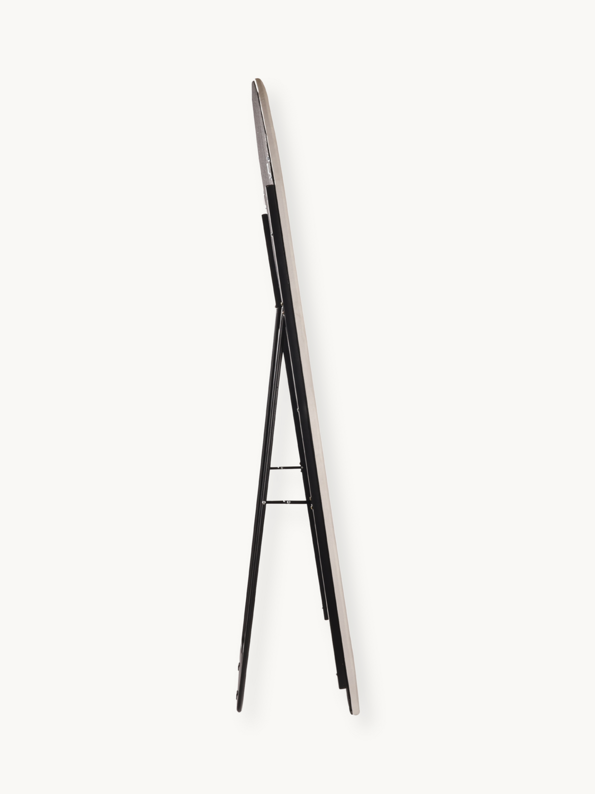 Side profile view of white suede velvet oval standing mirror showing slim frame edge and black metal A-frame support legs