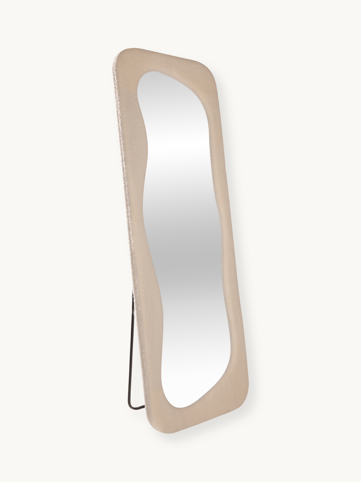 Felis standing mirror in teddy white, angled three-quarter view showing wavy glass, bouclé frame texture, and black metal…