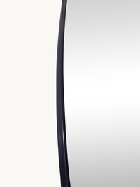Close-up of Rafael mirror's curved left edge showing slim black PVC frame profile against white background
