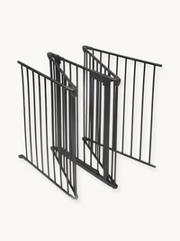 Three black metal freestanding gate panels folded in a zigzag stack, angled three-quarter view showing hinge connectors an…