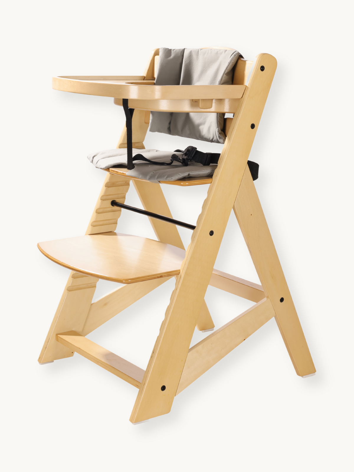 Natural wood highchair angled view showing adjustable footrest platform, grey seat cushion, harness, and attached wooden tray