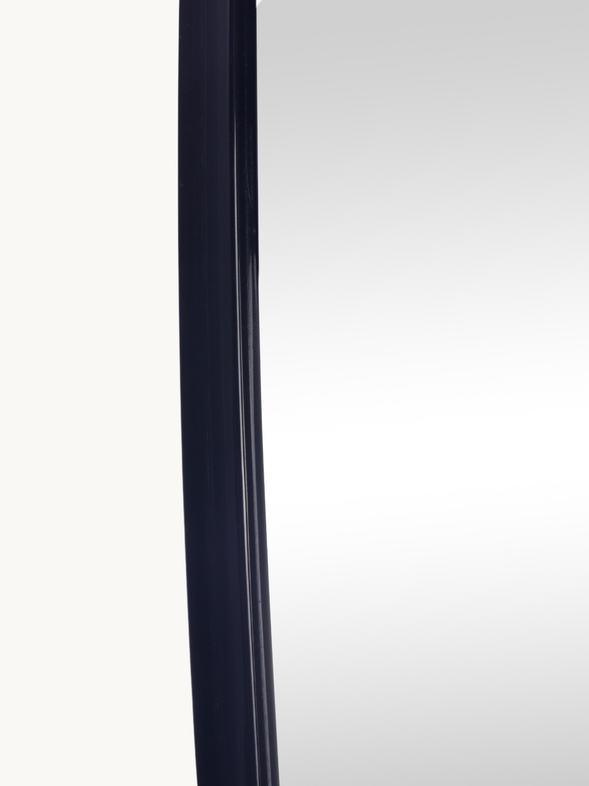 Close-up of slim black PVC left-side frame edge on Leandro organic wall mirror, showing profile depth and finish detail