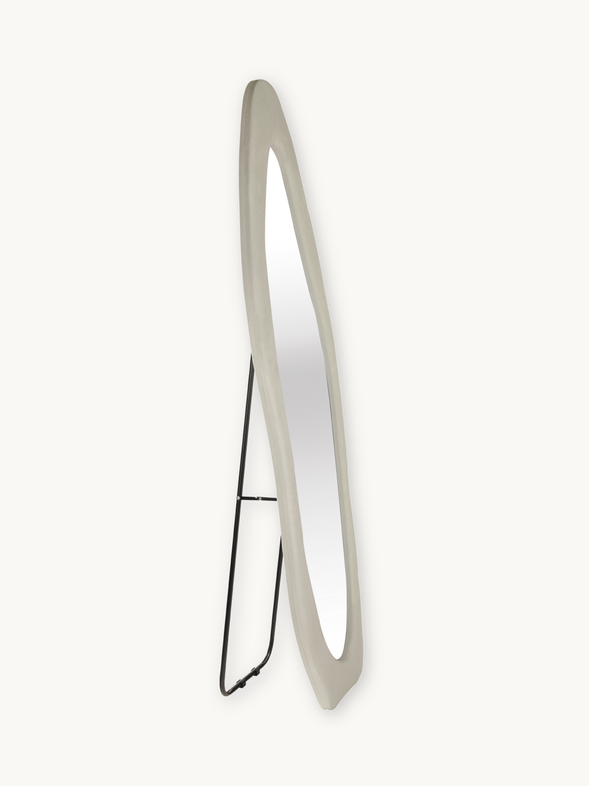 Rear three-quarter view of tall asymmetric white suede velvet framed standing mirror showing black metal easel support stand