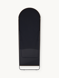 Back view of full-length arched mirror showing dark backing panel, brown aluminium frame, and black metal floor stand base.