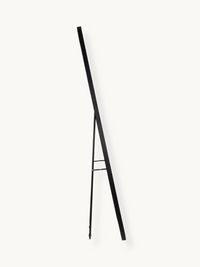 Black aluminium standing mirror easel stand shown from the side, displaying the slim tripod leg structure and crossbar brace