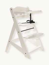 White wooden adjustable baby high chair with removable tray and black safety harness, angled three-quarter view