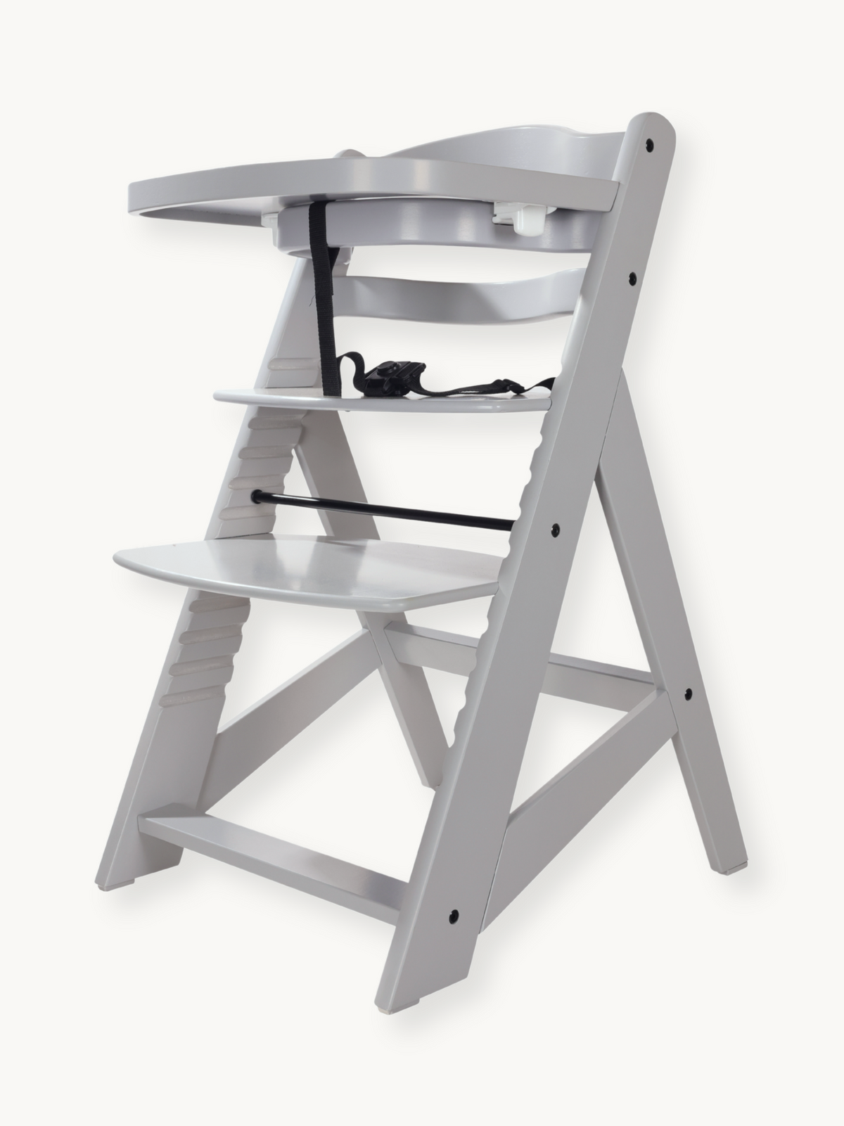 Grey wooden highchair angled front-left view, tray attached, black harness visible, adjustable footrest and seat, no cushi…