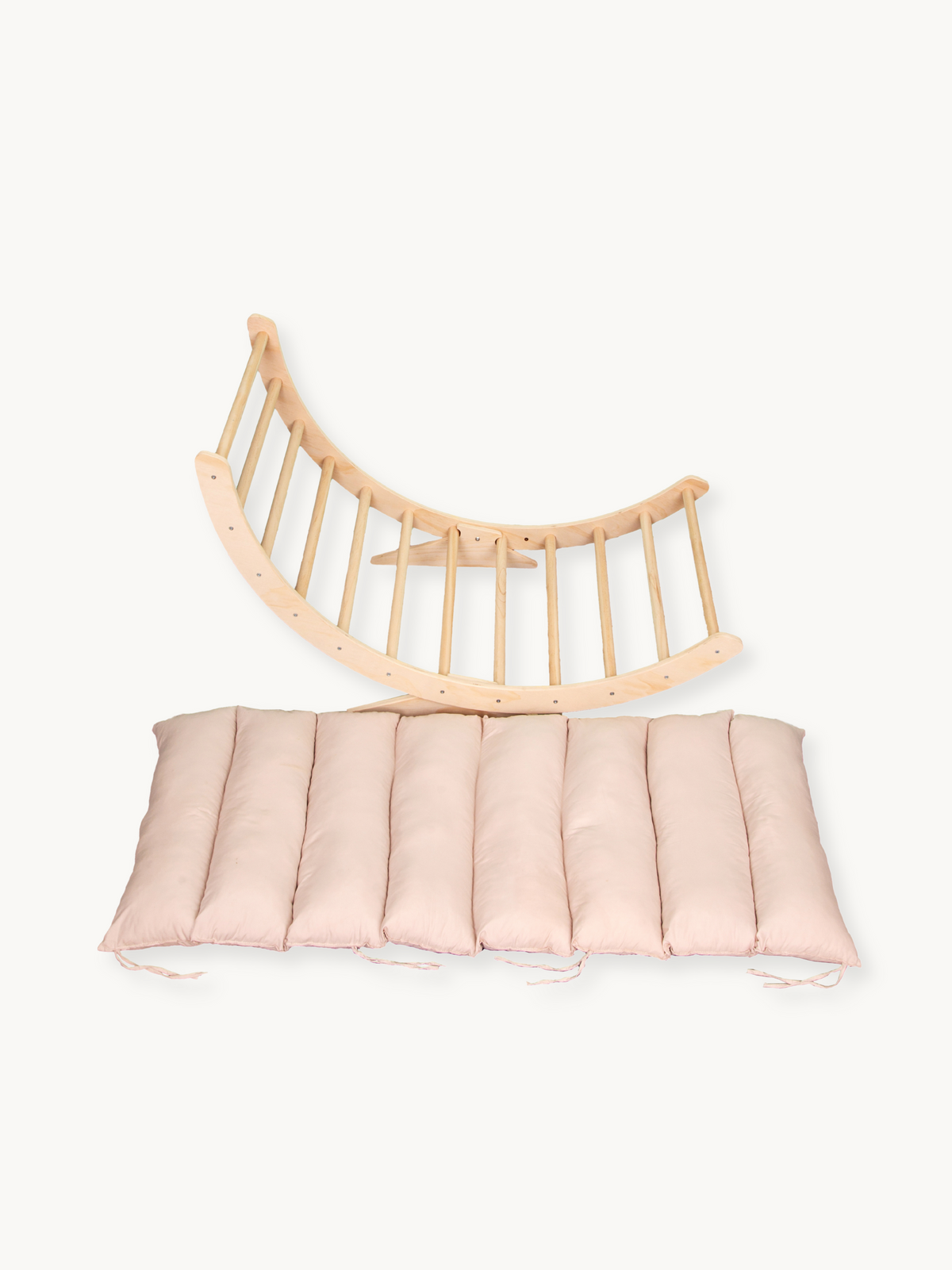 Natural wood XXL climbing arch rocker shown flat with detached blush pink quilted cushion, overhead product view on white…