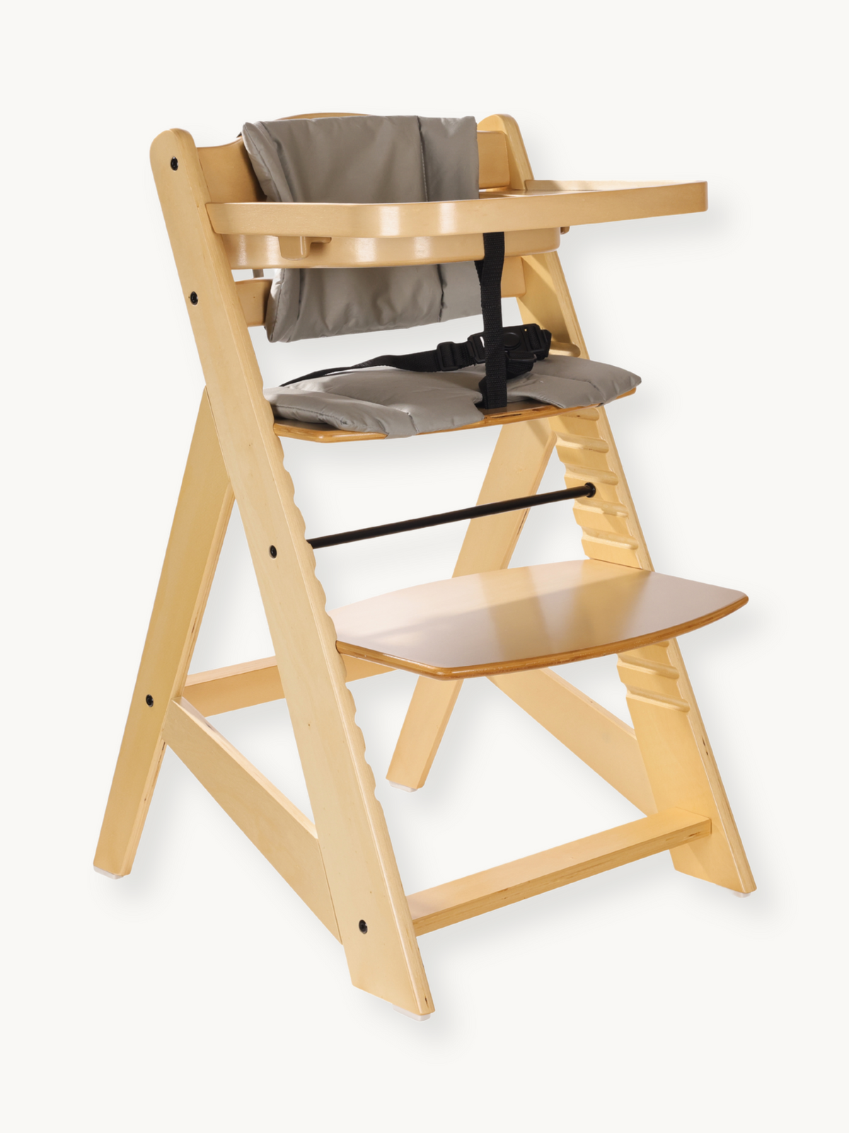 Natural wood baby highchair with grey cushion, black harness, and attached tray, angled three-quarter view on white backgr…