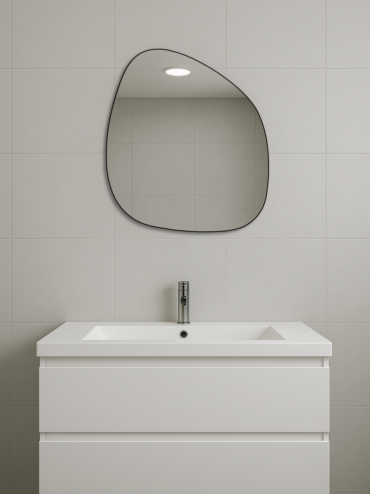 Alaric organic mirror with thin black PVC frame hung above white bathroom vanity and sink, grey tiled wall, lifestyle setting