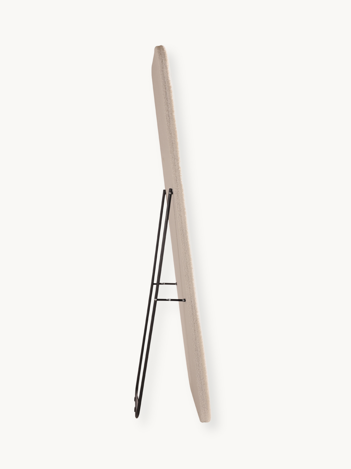 Side profile of Felis standing mirror showing cream teddy fabric edge and black metal foldout support stand, white background