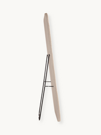 Side profile of Felis standing mirror showing cream teddy fabric edge and black metal foldout support stand, white background