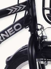 Close-up of black fork junction, rim caliper brake, and front mudguard on the Borneo 12-inch kids bike frame