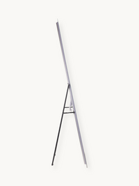 Side profile of LED standing mirror on black tripod easel stand, power cable visible, white background, 160 cm tall
