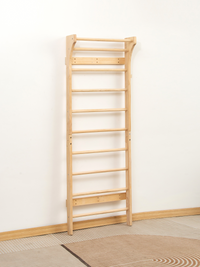 Natural wood Swedish wall bar leaning against white wall, full-length angled view on striped rug, showing two-section fram…