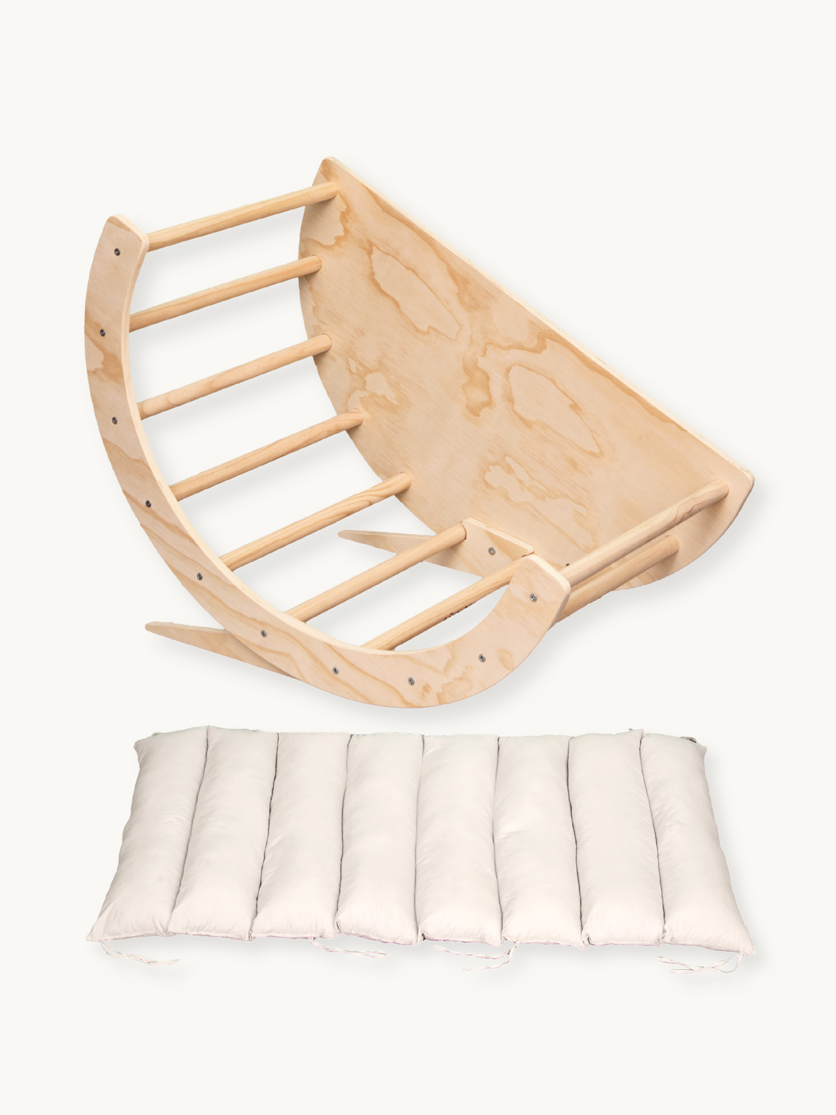 Natural birch wood climbing arch and rocker shown overhead, with detached cream segmented cushion below