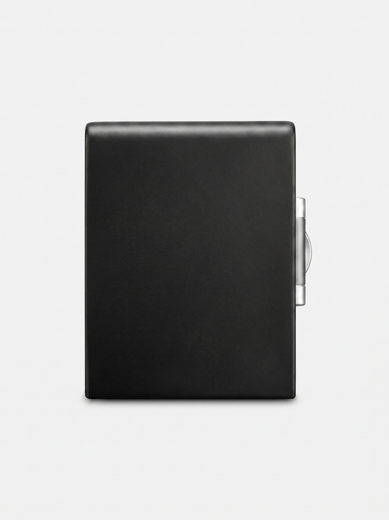 Black leather-wrapped fireproof safe rear exterior, smooth surface with silver hinge mechanism visible on right edge, whit…