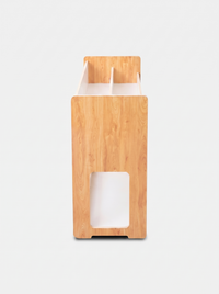 Narrow end-panel view of natural pine kids bookcase showing rounded corners, rectangular cutout, and divided top slots, wh…