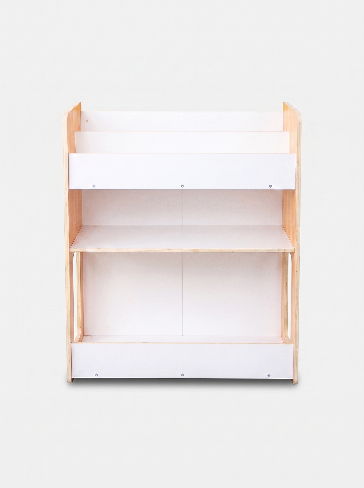 Front-on view of empty three-tier kids bookcase, natural pine sides, white panel shelves, bottom storage rail, no bins ins…