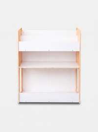 Front-on view of empty three-tier kids bookcase, natural pine sides, white panel shelves, bottom storage rail, no bins ins…