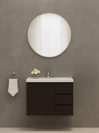 Freya round mirror with slim gold frame mounted above dark wood bathroom vanity, lifestyle bathroom setting