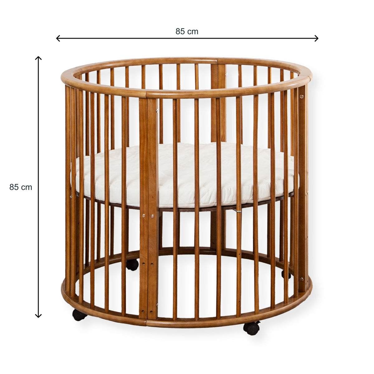 Walnut-finish round wooden baby playpen with dimension lines showing 85 cm width and 85 cm height, white mattress inside,…