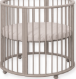 Clay wooden round baby playpen with slatted sides on wheels, front angle view